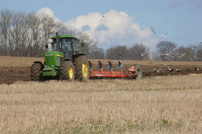 Framed Print : John Deere 4255 tractor pulling Kverneland plough followed by Black-headed Gull and rook flock