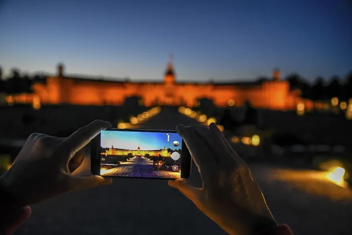 Framed Print : Karlsruhe castle at dusk in the display of a mobile phone