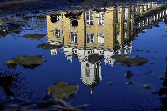 Framed Print : Karlsruhe Castle reflected in a puddle in autumn