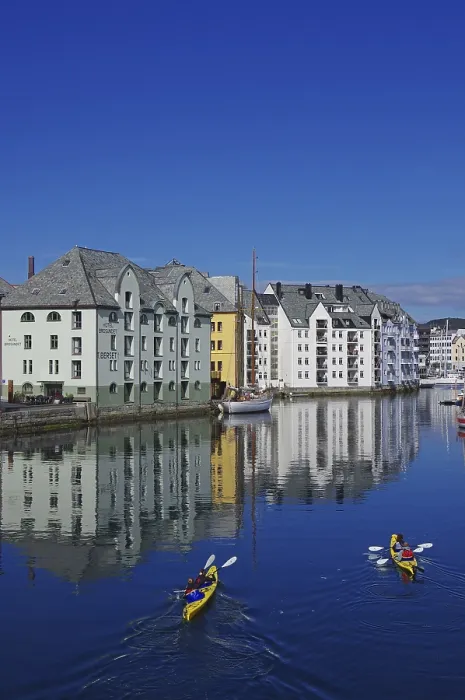 Framed Print : Kayakers, stone houses reflected in a harbour basin