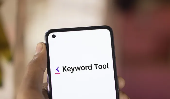 Framed Print : keyword tool logo is displayed on smartphone