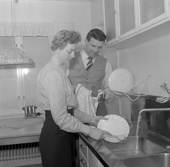 Framed Print : In the kitchen 1950s. A young couple is doing the dishes in the kitchen, she cleans the plates and he dries them with a towel. He is singer Cacka Israelsson, 1929-2013. Sweden 1954. Conard ref 2643 Framed Print : In the kitchen 1950s. A young couple is doing the dishes in the kitchen, she cleans the plates and he dries them with a towel. He is singer Cacka Israelsson, 1929-2013. Sweden 1954. Conard ref 2643