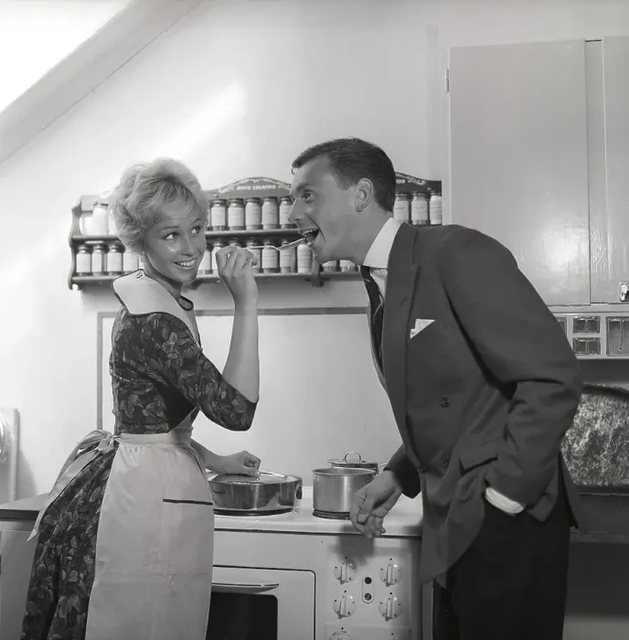 Framed Print : In the kitchen 1950s. A young couple in their kitchen Framed Print : In the kitchen 1950s. A young couple in their kitchen