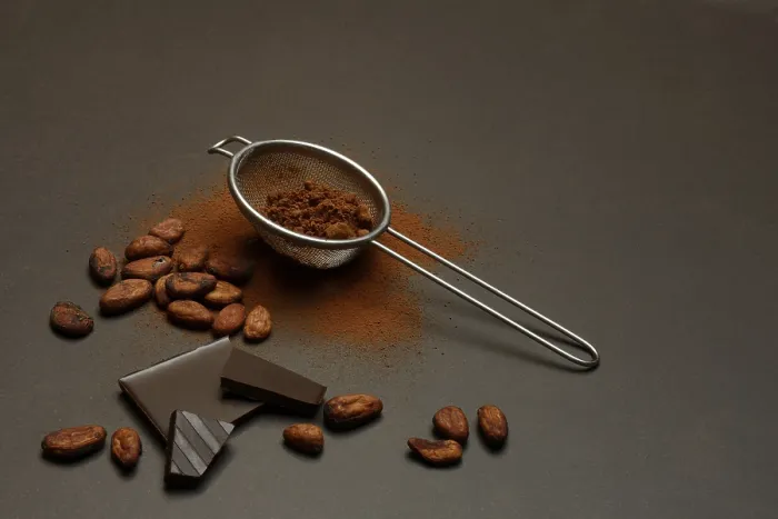 Framed Print : Kitchen sieve with cocoa powder and chocolate