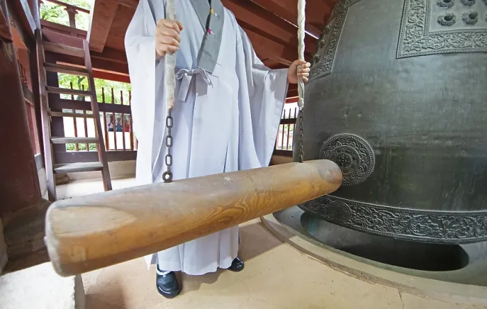 Framed Print : Korean monk strikes the bell with a wooden trunk Framed Print : Korean monk strikes the bell with a wooden trunk