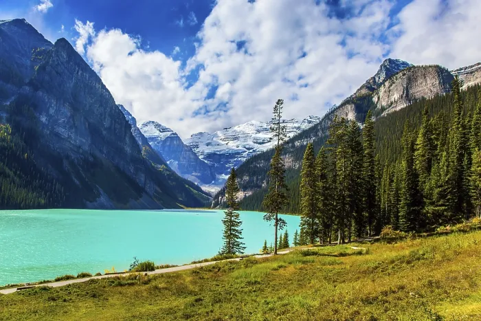 Framed Print : The lake with azure water is surrounded by mountains and forests