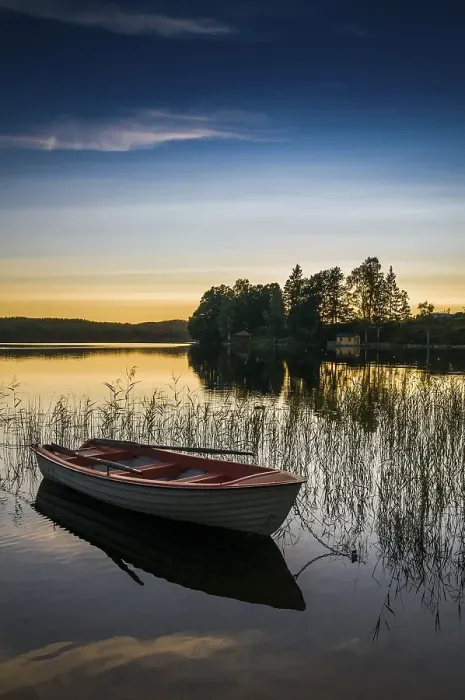 Framed Print : Lake and rowing boat at sunset in Bengtsfors