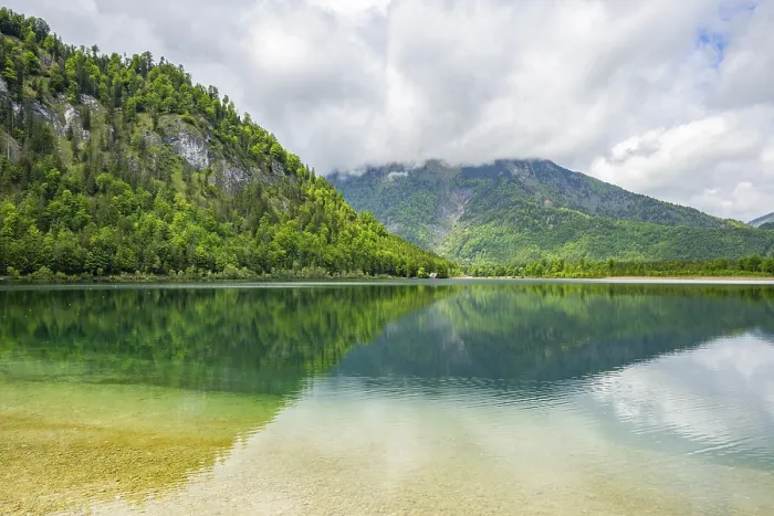 Framed Print : Landscape of Lake Offensee after rain when the sun comes through the clouds in spring