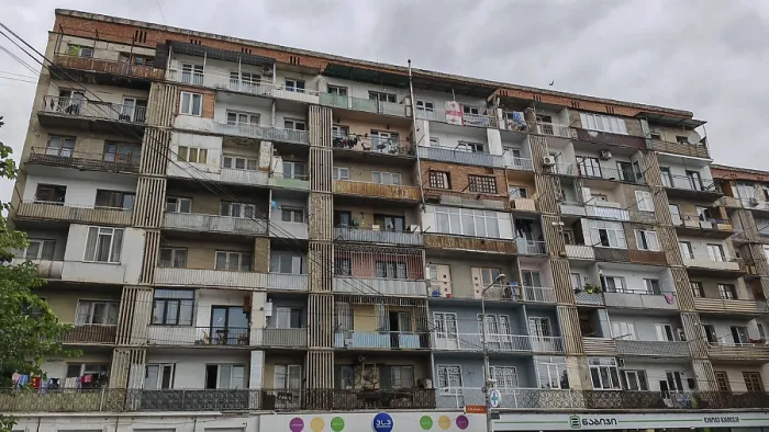 Framed Print : Large apartment block with many floors and balconies under cloudy sky