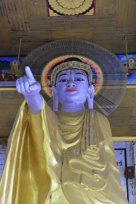 Framed Print : Large Buddha statue in golden robe with glowing halo and extended finger