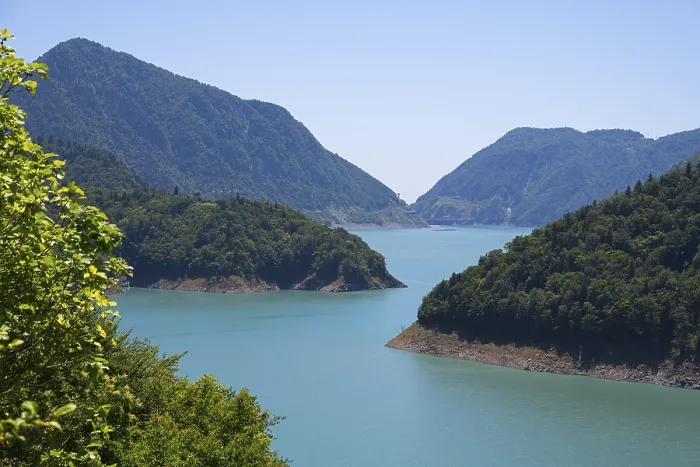 Framed Print : Large, calm lake surrounded by forested mountains