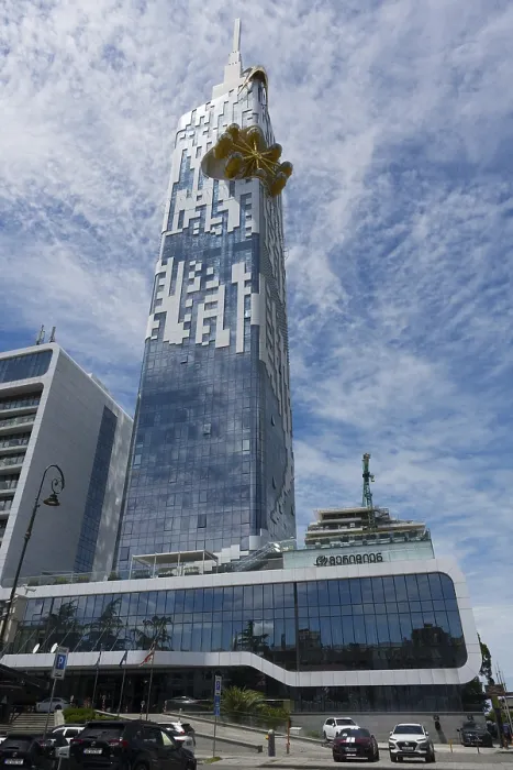 Framed Print : A large high-rise building with a glass facade stands in an urban environment