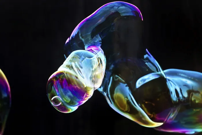Framed Print : Large, iridescent soap bubble tube in the colours of the rainbow against a black background Framed Print : Large, iridescent soap bubble tube in the colours of the rainbow against a black background