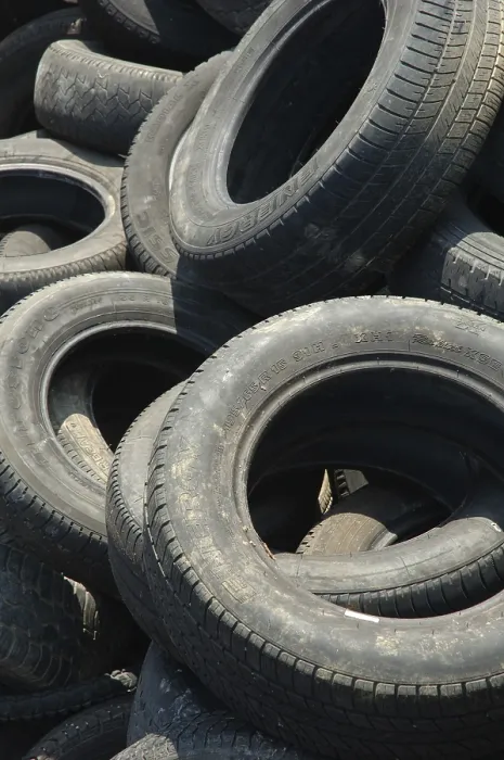 Framed Print : A large pile of old, worn tires stacked haphazardly Framed Print : A large pile of old, worn tires stacked haphazardly