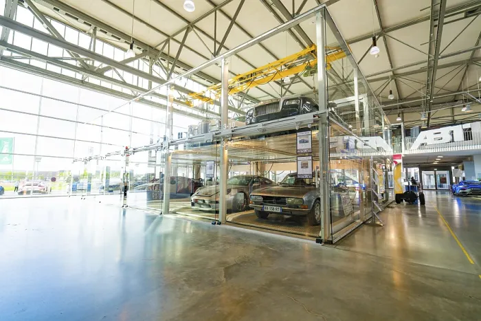 Framed Print : Large room with glass garage and several cars