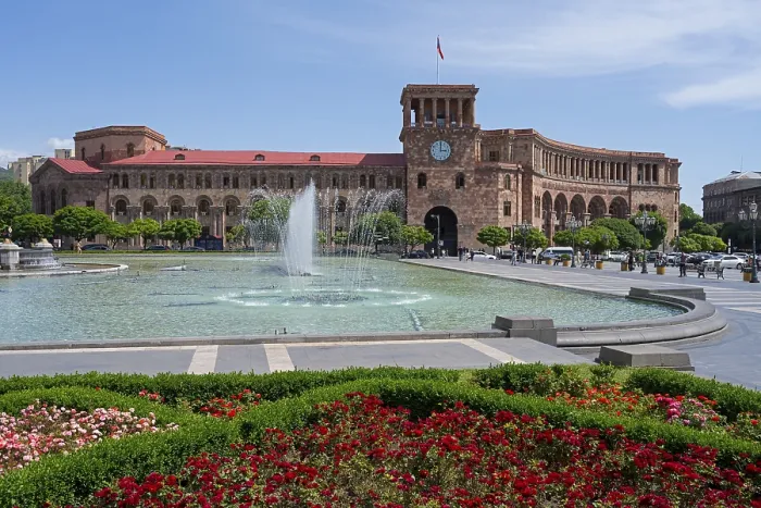 Framed Print : Large square with fountain, surrounded by flower beds and a historic building with clock