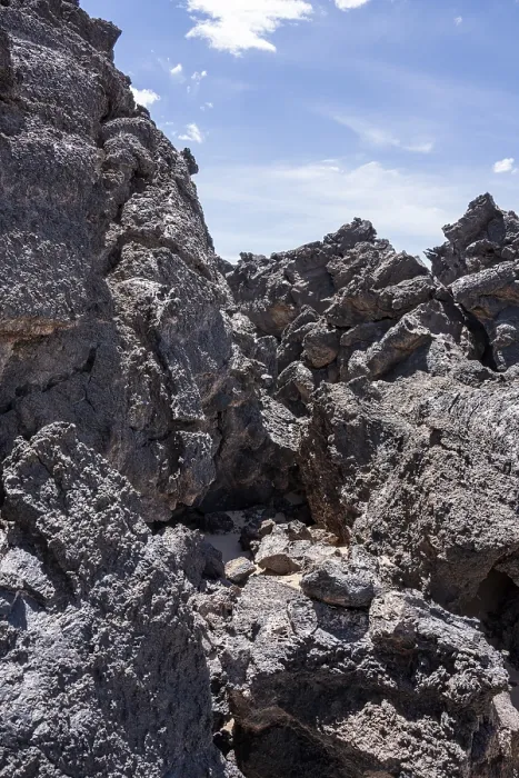 Framed Print : Large, weathered lava rocks under a clear blue sky