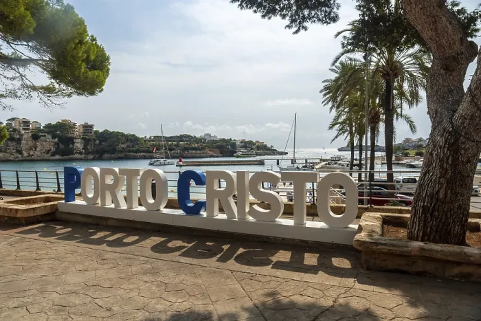 Framed Print : Large white and blue letters spelling porto cristo stand on a paved promenade Framed Print : Large white and blue letters spelling porto cristo stand on a paved promenade