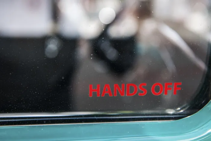 Framed Print : Lateral partial view of the side window of a vintage car with the inscription hands off Framed Print : Lateral partial view of the side window of a vintage car with the inscription hands off
