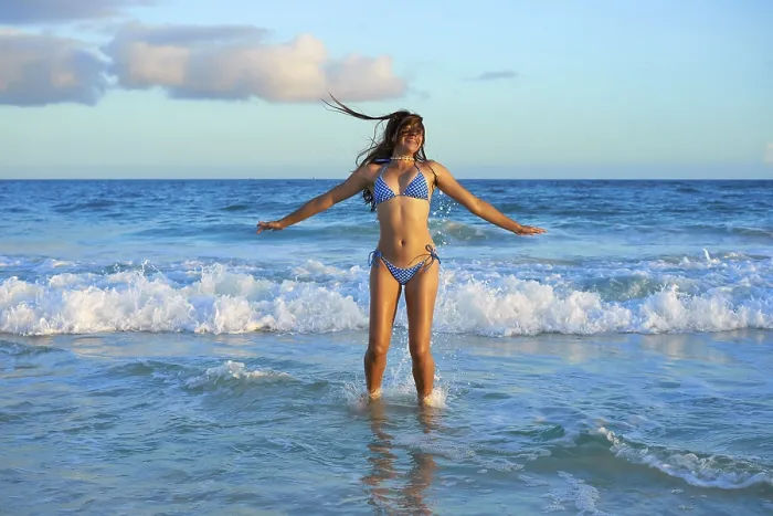 Framed Print : Latin beautiful bikini girl happy jumping in Caribbean beach sunset