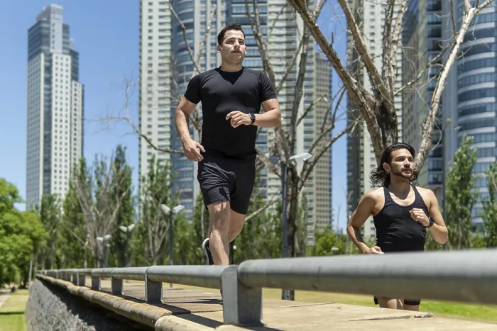 Framed Print : Two latin men running in a park surrounded by modern skyscrapers Framed Print : Two latin men running in a park surrounded by modern skyscrapers