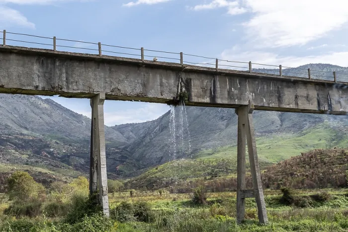 Framed Print : Leaky aqueduct with waterfall against mountain backdrop Framed Print : Leaky aqueduct with waterfall against mountain backdrop