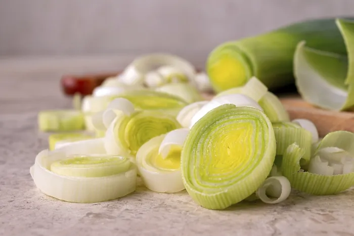 Framed Print : Leek cut into slices on a wooden board