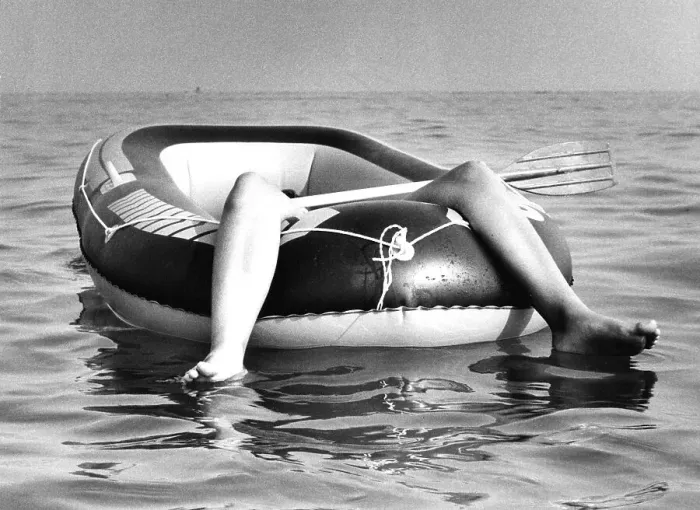 Framed Print : Two legs in rubber dinghy, ca. 1980s