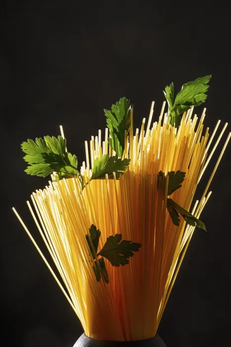 Framed Print : Still life, spaghetti with flat-leaf parsley in a black container