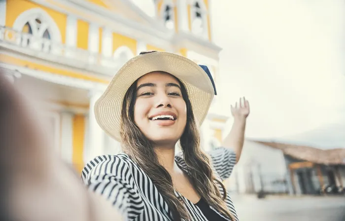 Framed Print : Lifestyle of tourist girl in hat taking a selfie in a square