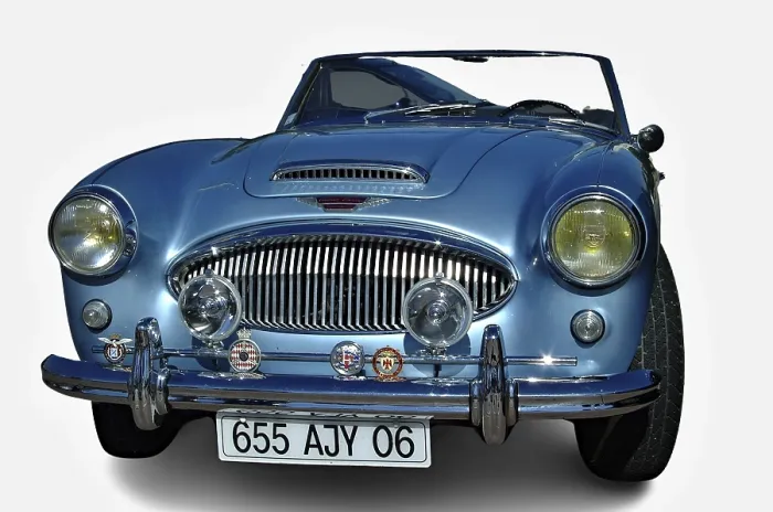 Framed Print : Light blue Austin Healey 3000 with open roof parked with white background