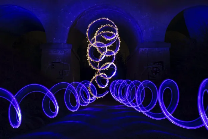 Framed Print : Light painting with blue and yellow spirals forming glowing patterns in the dark