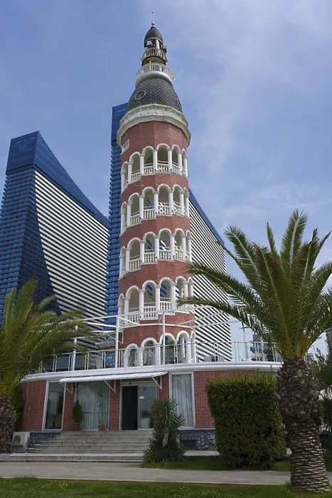Framed Print : A lighthouse in front of a modern skyscraper