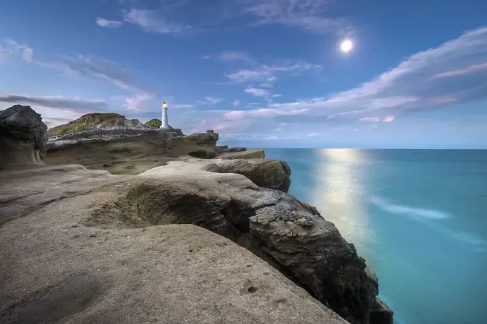 Framed Print : Lighthouse at full moon on the cliffs of lava rock at Castlepoint