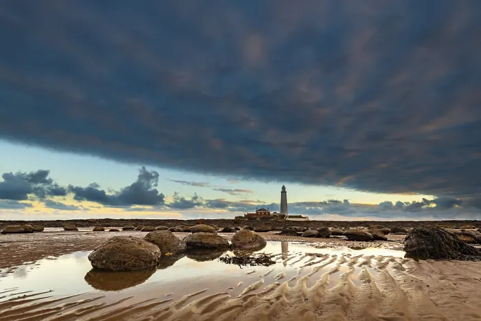 Framed Print : Lighthouse, St. Mary's Lighthouse at low tide with clouds at sunrise