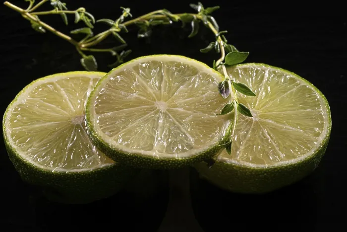 Framed Print : Three lime slices with green decoration on a stone plate