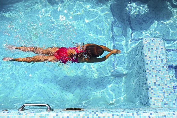 Framed Print : Little girl swimming in the outdoor pool