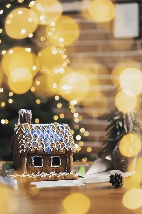 Framed Print : Little homemade gingerbread house with glaze standing on the table with decorations