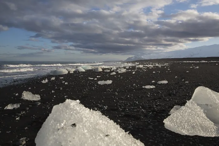 Framed Print : Little icebergs and crushed ice on the black beach at Joekulsarlon glacial lake