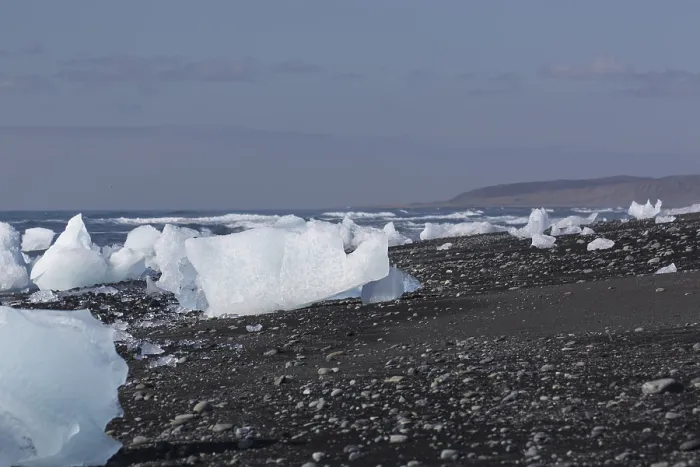 Framed Print : Little icebergs and crushed ice on the black beach at Joekulsarlon glacial lake