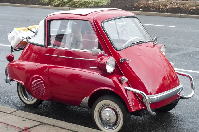 Framed Print : Little red old vintage car on street background