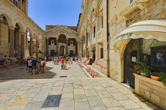 Framed Print : Lively historic square with architectural details and visitors