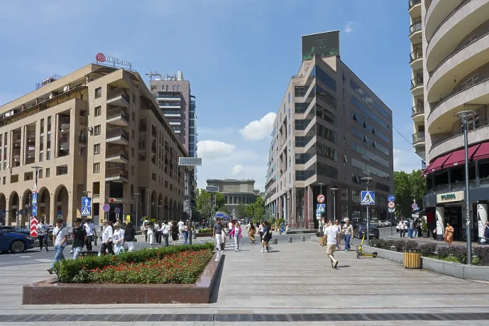 Framed Print : Lively urban street lined with modern buildings and pedestrians