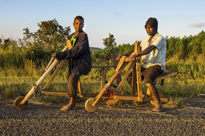 Framed Print : Local boys on their self made bicycles, Malawi