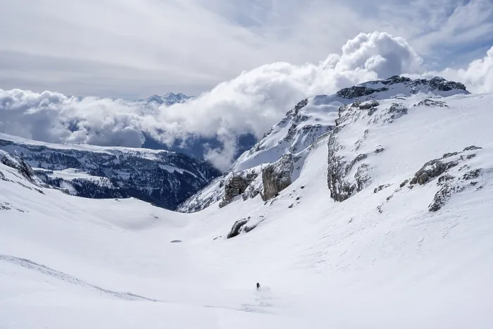 Framed Print : Lone ski tourer descending in fresh snow