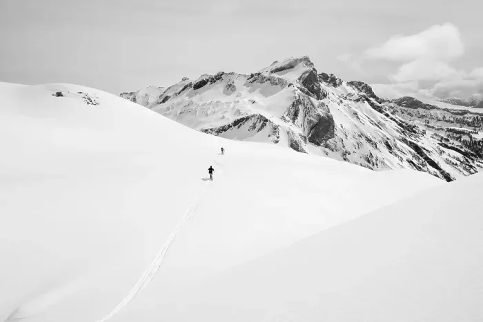 Framed Print : Two lonely ski tourers in a snowy mountain landscape