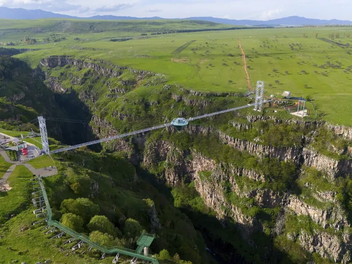 Framed Print : A long bridge with a glass platform spans a deep gorge