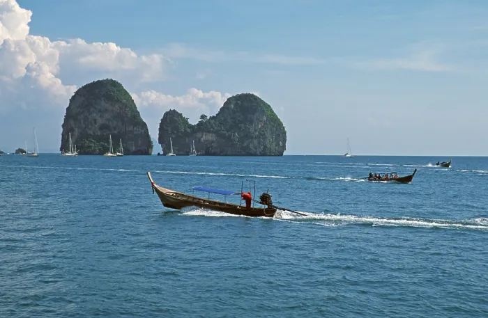 Framed Print : Longtail boats, rocks in the sea