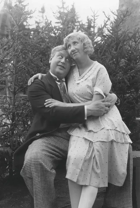 Framed Print : Love in the 1930s. A couple and where she sits on his lap and they are hugging each other tenderly