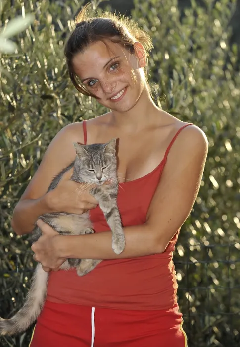 Framed Print : Love of animals, young woman holding tabby cat
